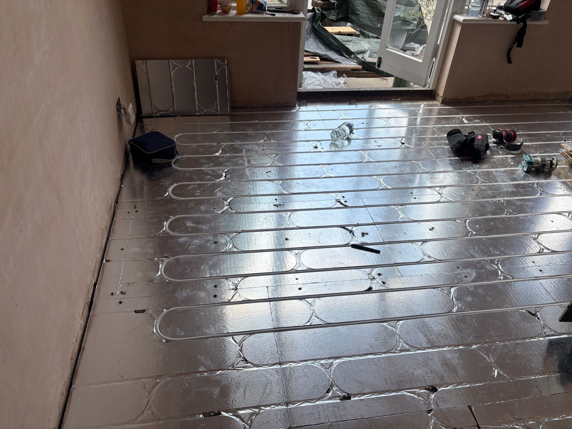 Structural chipboard underfloor heating deck with the pipe laid in